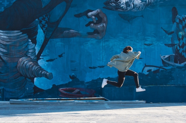 boy jumping near wall