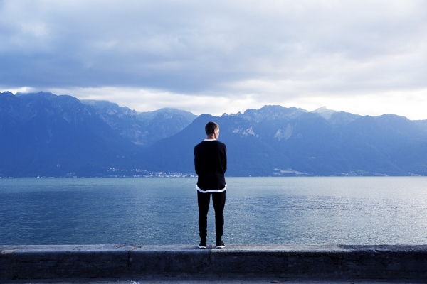 person wearing black pants and top standing on wall