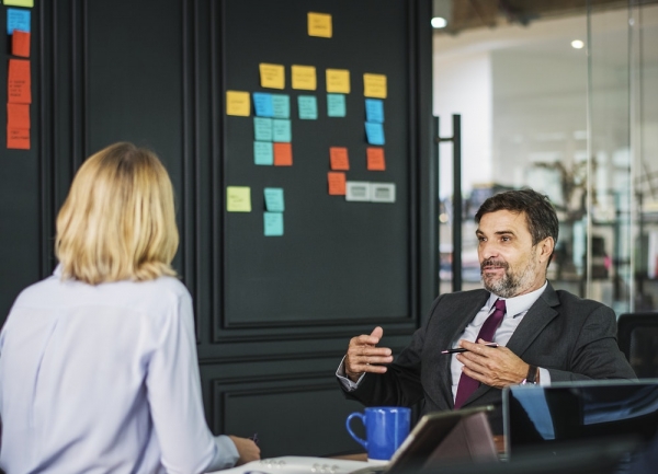 man talking in front of woman