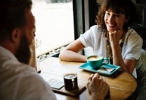 Woman in White Shirt Beside Teacup