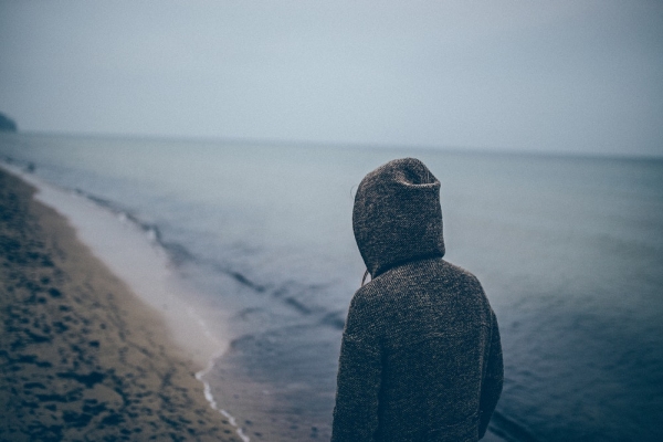 person standing beside seashore