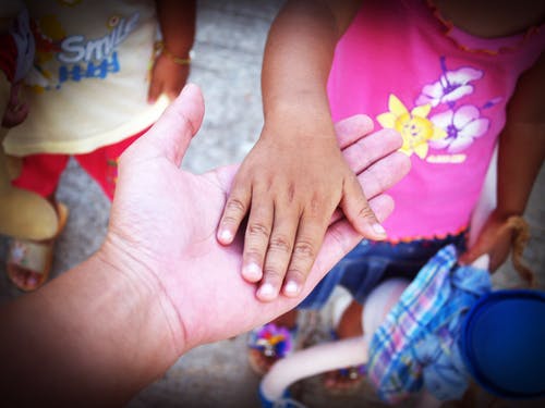 Person Holding Toddler's Hand