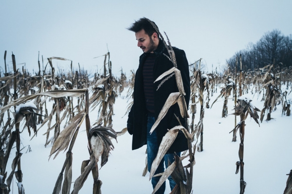 man standing on snowy field